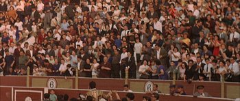 Movie still from “The Moment of Truth” (1965), directed by Francesco Rosi – A crowd of people standing in front of a stadium; Extreme Wide shot, High angle