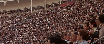 Movie still from “The Moment of Truth” (1965), directed by Francesco Rosi – A crowd of people sitting in the stands at a sporting event; Extreme Wide shot, High angle