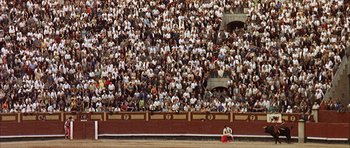 Movie still from “The Moment of Truth” (1965), directed by Francesco Rosi – A crowd of people sitting in front of an audience; Extreme Wide shot, High angle
