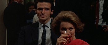 Movie still from “The Moment of Truth” (1965), directed by Francesco Rosi – A man and a woman are holding a drink; Close Up shot, Low angle