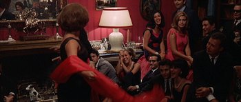Movie still from “The Moment of Truth” (1965), directed by Francesco Rosi – A group of people sitting in a living room next to each other; Wide shot, Low angle