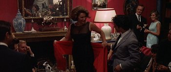 Movie still from “The Moment of Truth” (1965), directed by Francesco Rosi – A woman in a black dress holding onto a red shawl; Medium shot, Over the shoulder angle