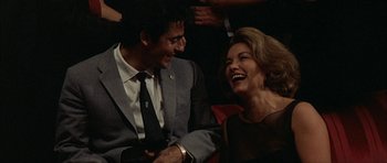 Movie still from “The Moment of Truth” (1965), directed by Francesco Rosi – A man and a woman laughing together in front of a crowd; Close Up shot, High angle