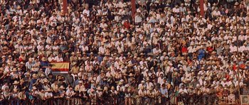 Movie still from “The Moment of Truth” (1965), directed by Francesco Rosi – A crowd of people sitting on bleachers in a stadium; Extreme Wide shot, High angle