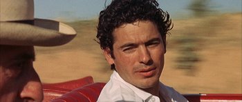 Movie still from “The Moment of Truth” (1965), directed by Francesco Rosi – A person wearing a white shirt; Close Up shot, Low angle