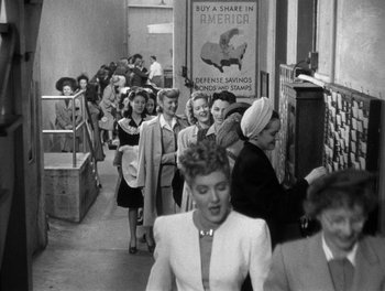 Movie still from “The More the Merrier” (1943), directed by George Stevens – A group of women walking down a hallway; Wide shot, High angle