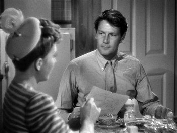 Movie still from “The More the Merrier” (1943), directed by George Stevens – A man and a woman sitting at a dinner table; Medium shot, Over the shoulder angle