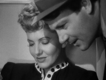 Movie still from “The More the Merrier” (1943), directed by George Stevens – A man and a woman looking at one another; Close Up shot, Overhead angle