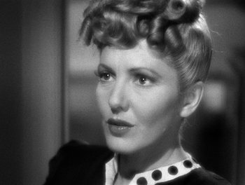 Movie still from “The More the Merrier” (1943), directed by George Stevens – An old photo of a woman in a black and white photo; Close Up shot, Over the shoulder angle