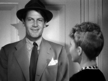 Movie still from “The More the Merrier” (1943), directed by George Stevens – A man in a suit and a boy in a hat; Close Up shot, Over the shoulder angle