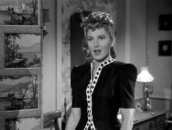 Movie still from “The More the Merrier” (1943), directed by George Stevens – A black and white photo of a woman in a black dress; Close Up shot, Over the shoulder angle