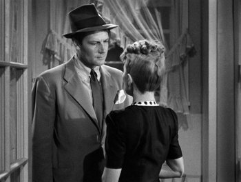 Movie still from “The More the Merrier” (1943), directed by George Stevens – A man and a woman are standing in front of a mirror; Medium shot, Over the shoulder angle