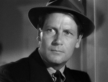 Movie still from “The More the Merrier” (1943), directed by George Stevens – A man wearing a suit and a hat; Close Up shot, Low angle