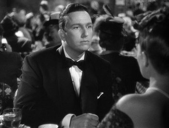 Movie still from “The More the Merrier” (1943), directed by George Stevens – A black and white photo of a man in a tuxedo; Close Up shot, Over the shoulder angle