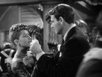 Movie still from “The More the Merrier” (1943), directed by George Stevens – A man and a woman in formal dress; Close Up shot, Over the shoulder angle
