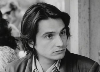 Movie still from “The Mother and the Whore” (1973), directed by Jean Eustache – Black and white photograph of a man with long hair; Close Up shot, High angle