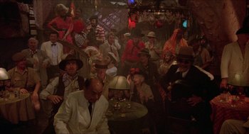 Movie still from “The Muppet Movie” (1979), directed by James Frawley – A group of people sitting at a table in a room; Wide shot, High angle