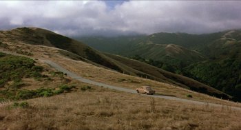 Movie still from “The Muppet Movie” (1979), directed by James Frawley – A car driving down a road on a hill; Extreme Wide shot, High angle