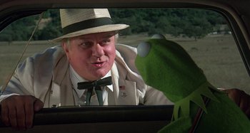 Movie still from “The Muppet Movie” (1979), directed by James Frawley – A man wearing a hat looking in a mirror; Close Up shot, Over the shoulder angle