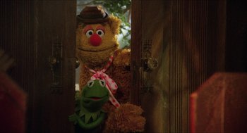 Movie still from “The Muppet Movie” (1979), directed by James Frawley – Two stuffed animals sitting next to each other in a room; Medium shot, Over the shoulder angle