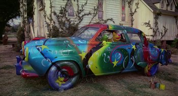 Movie still from “The Muppet Movie” (1979), directed by James Frawley – A car painted with colorful stars and swirly designs; Wide shot, Low angle
