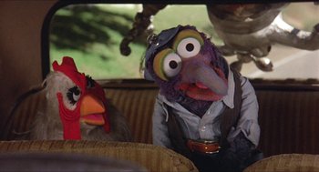Movie still from “The Muppet Movie” (1979), directed by James Frawley – A couple of birds sitting next to each other on top of a couch; Close Up shot, High angle