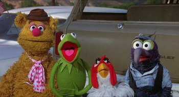 Movie still from “The Muppet Movie” (1979), directed by James Frawley – A group of stuffed animals sitting next to each other in a car; Medium shot, Low angle