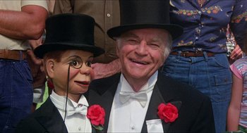Movie still from “The Muppet Movie” (1979), directed by James Frawley – A man in a suit and top hat with a man in a suit and top hat; Close Up shot, High angle