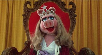 Movie still from “The Muppet Movie” (1979), directed by James Frawley – A woman in a crown sitting in a chair; Close Up shot, High angle