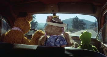 Movie still from “The Muppet Movie” (1979), directed by James Frawley – A girl in the back seat of a car with stuffed animals in the back seat; Close Up shot, High angle