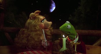 Movie still from “The Muppet Movie” (1979), directed by James Frawley – A couple of stuffed animals sitting next to each other on top of a table; Medium shot, High angle