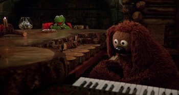 Movie still from “The Muppet Movie” (1979), directed by James Frawley – Two stuffed animals sitting on top of a piano; Medium shot, High angle
