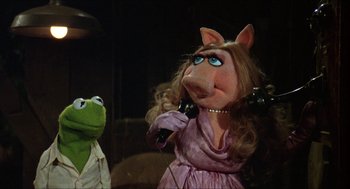 Movie still from “The Muppet Movie” (1979), directed by James Frawley – A woman in a pink dress talking on a phone; Close Up shot, High angle