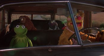 Movie still from “The Muppet Movie” (1979), directed by James Frawley – A group of stuffed animals sitting in the back seat of a car; Wide shot, High angle