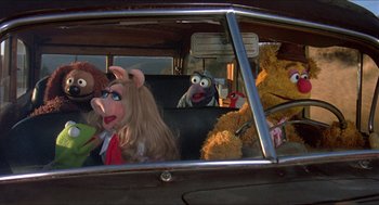 Movie still from “The Muppet Movie” (1979), directed by James Frawley – A group of people in a car looking out the window; Medium shot, High angle