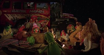 Movie still from “The Muppet Movie” (1979), directed by James Frawley – A group of stuffed animals sitting next to each other on the ground; Wide shot, High angle
