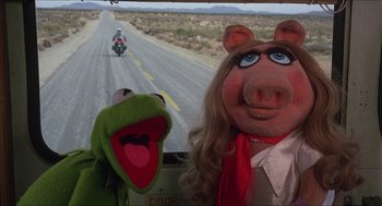 Movie still from “The Muppet Movie” (1979), directed by James Frawley – A couple of muppets are standing next to each other; Close Up shot, High angle