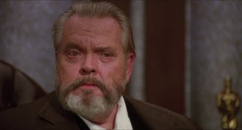 Movie still from “The Muppet Movie” (1979), directed by James Frawley – An older man with a beard and a mustache; Close Up shot, Low angle