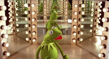 Movie still from “The Muppet Movie” (1979), directed by James Frawley – A group of kermit the frog stuffed animals in front of a mirror; Medium shot, High angle