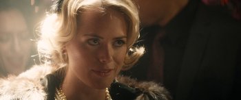 Movie still from “The Night Before” (2015), directed by Jonathan Levine – A person wearing a necklace; Close Up shot, Over the shoulder angle