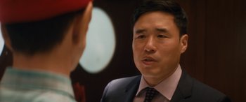 Movie still from “The Night Before” (2015), directed by Jonathan Levine – A man wearing a suit and tie talking to another man wearing a suit and tie; Close Up shot, Over the shoulder angle