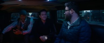 Movie still from “The Night Before” (2015), directed by Jonathan Levine – A group of people sitting in a car at night; Medium shot, High angle
