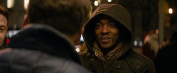 Movie still from “The Night Before” (2015), directed by Jonathan Levine – A man wearing a hooded jacket talking to another man; Close Up shot, Over the shoulder angle