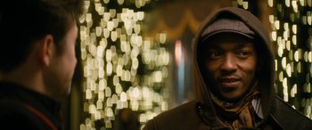 Movie still from “The Night Before” (2015), directed by Jonathan Levine – A man in a hooded jacket standing in front of a christmas tree; Close Up shot, Over the shoulder angle