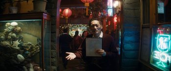Movie still from “The Night Before” (2015), directed by Jonathan Levine – An older man holding a menu in front of a crowd; Medium shot, Over the shoulder angle