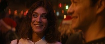 Movie still from “The Night Before” (2015), directed by Jonathan Levine – A woman smiles at a man in a santa suit; Close Up shot, Over the shoulder angle