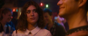 Movie still from “The Night Before” (2015), directed by Jonathan Levine – A woman in a white shirt is in a crowd of people; Close Up shot, Over the shoulder angle