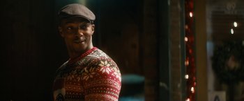 Movie still from “The Night Before” (2015), directed by Jonathan Levine – A man wearing a hat and a sweater; Close Up shot, Over the shoulder angle