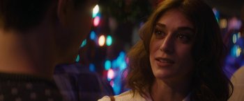 Movie still from “The Night Before” (2015), directed by Jonathan Levine – A woman's face in front of blurry lights; Close Up shot, Over the shoulder angle