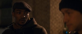 Movie still from “The Night Before” (2015), directed by Jonathan Levine – A man wearing a brown hat and a brown jacket; Close Up shot, Over the shoulder angle